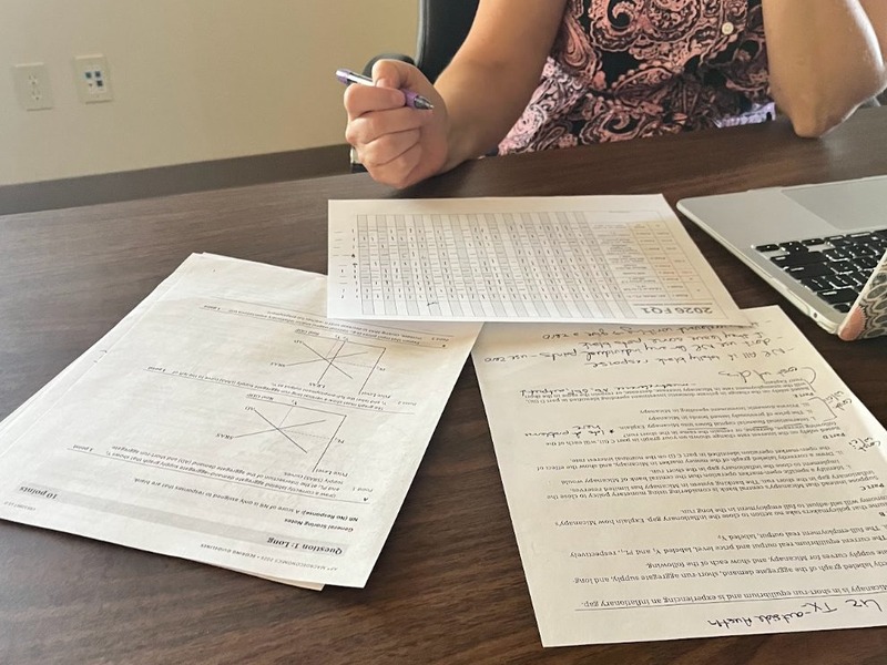Econiful Executive Director Megan Kirts reviewing AP Macroeconomics FRQ scoring materials at the 2026 AP Reading