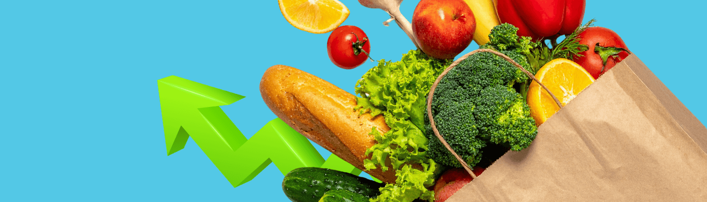 A paper grocery bag spilling out fresh vegetables, fruit, and bread beside a green upward arrow, illustrating how rising consumer prices are measured through the CPI market basket.