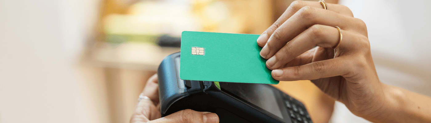 A person pays via tap with their credit card to demonstrate the use of credit in everyday life.